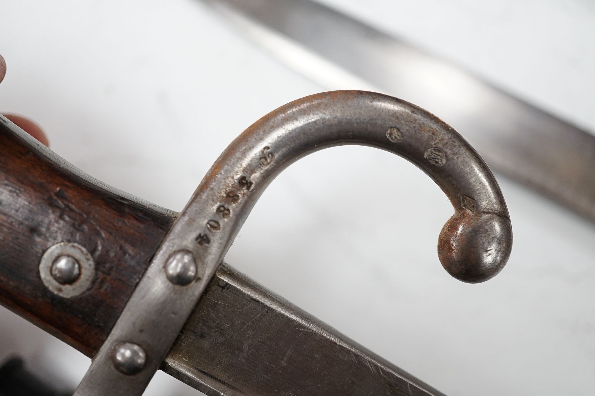 A French bayonet and scabbard with matching serial number (38804) and inscription and date to back of blade (1879) and another Solingen bayonet and scabbard